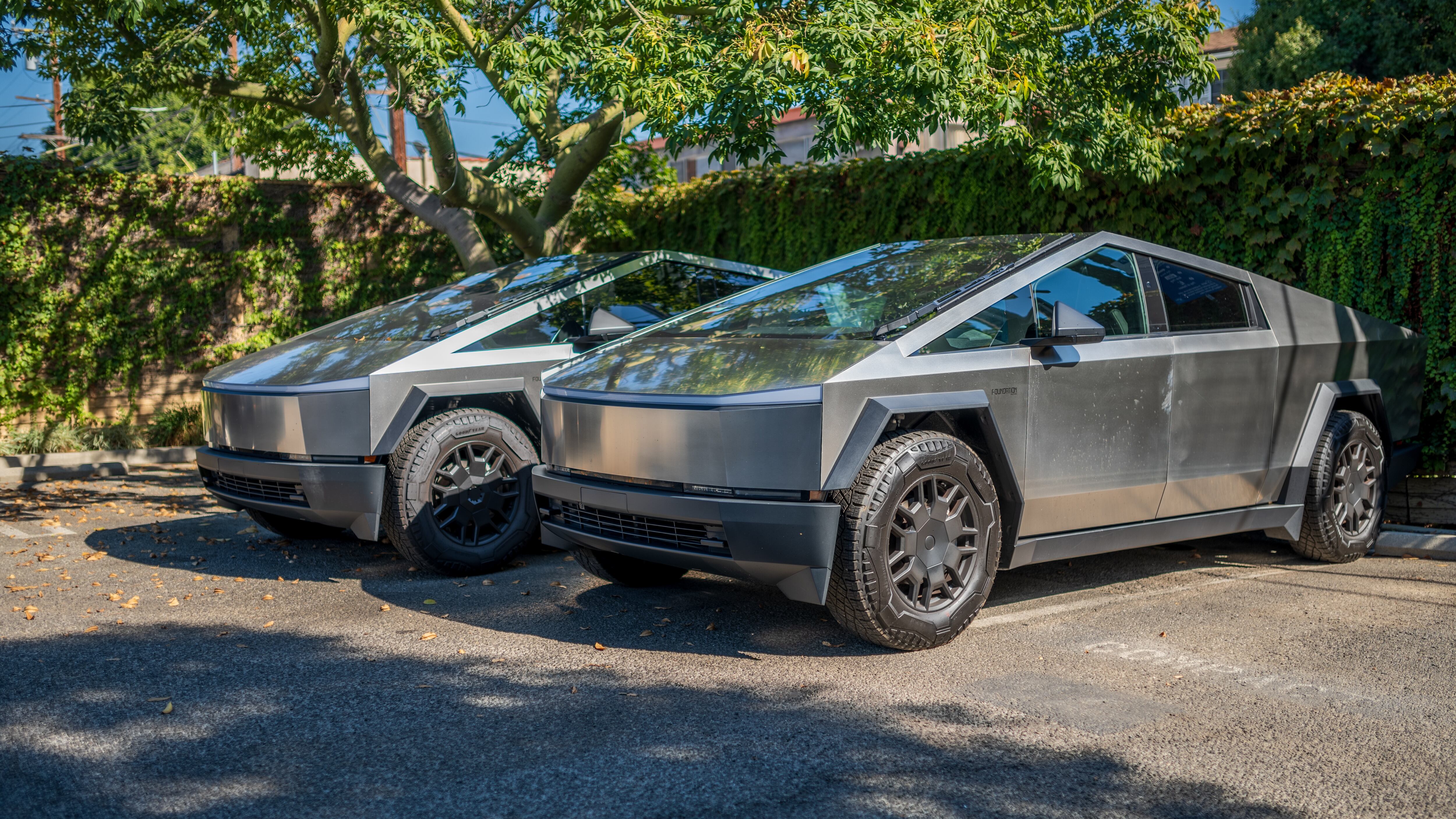 Two Cybertrucks in a driveway